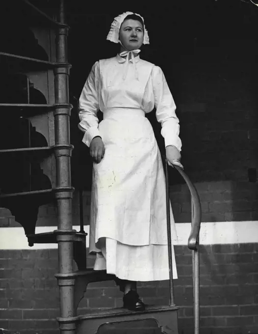 A trainee of Melbourne school of Nursing, wears frilled bonnet starched apron and long dress of 1904 period. Trainee Verna Blomquist models 1904 nurses's dress. September 2, 1955. 