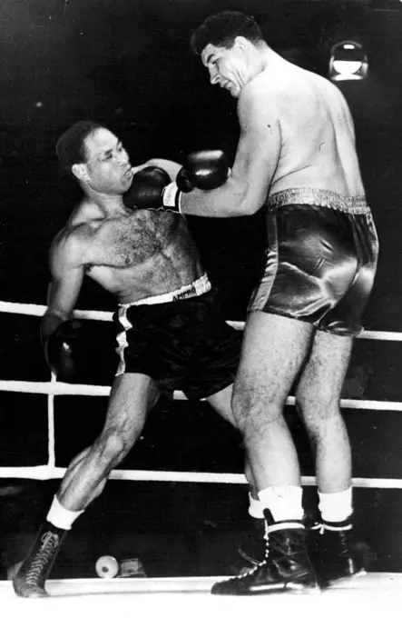 Boxing: Giant South African Wins Again In London Potgieter (right) places a left hand punch hard on the chin of Noel Reid. Ewart Potgieter, the giant South African heavyweight, defeated Noel Reid, of Jamaica in the 3rd round of their contest at the Harringay Arena, London, the referee stopping the fight to save Reid punishment. Potgieter weighed 23 stone 2 lb.; his opponent 15 stone 2lb. October 19, 1955. (Photo by Sports and General Press Agency Limited)