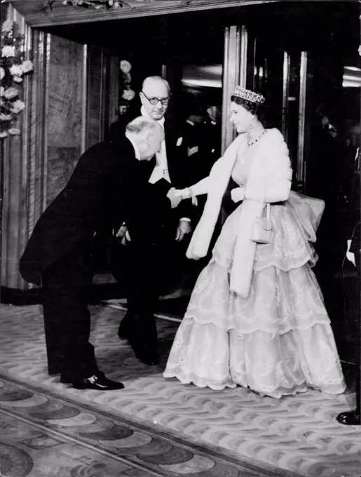 The Queen is here seen being greeted by Mr. Reginald Bromhead (Chairman and President of the Cinematographic trades benevolent fund. H.M. The Queen and The Duke of Edinburgh tonight attended the Royal Film performance at the Odeon, Leicester Square. October 26, 1953. (Photo by Paul Popper Ltd.).
