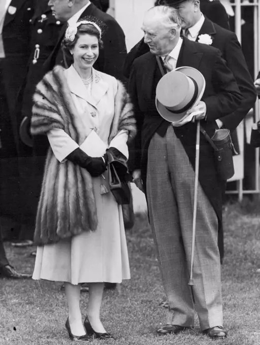 The Queen At Epsom. This afternoon's picture from Epsom shows The Queen who wore a petal hat and a mink stole over her shoulders, before the start of the Derby. Her entry, Landau, was un-placed. June 2, 1954.