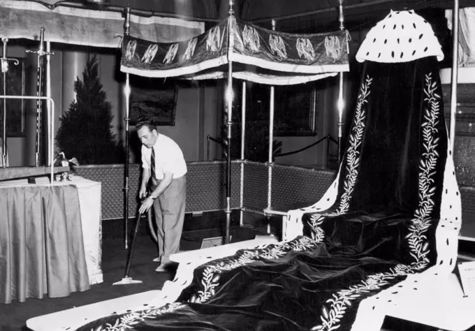 The Queen's Coronation robe, heavy and magnificent, is draped to full effect at the Crowning Robes Exhibition in Queen's Hall, Parliament House, today. Robes and symbols which have figured in the Coronations of British Kings and Queens for many generations will be on show until March 23. March 17, 1954.