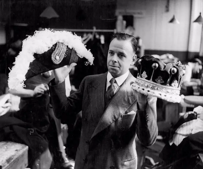 Before the war a coronet like this would have cost about £18, the price now is about £30. The Ambassador's hat would be £12 and Moss Bros, work room superintendent has hundreds of coronets and ceremonial hats to prepare for the coronation next year. Some will be hired. November 4, 1952. (Photo by Tom Blau, Camera Press Ltd.).