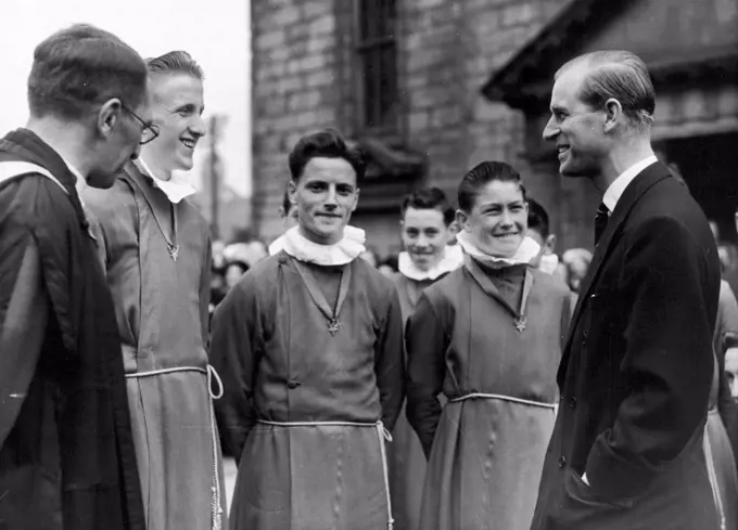 The Duke At Canongate Kirk. The Duke chatting to choir boys at the Canongate Kirk, Edinburgh. The Duke marked his visit by opening a new door and planting a tree in the Churchyard. June 29, 1953. (Photo by Paul Popper Ltd.).