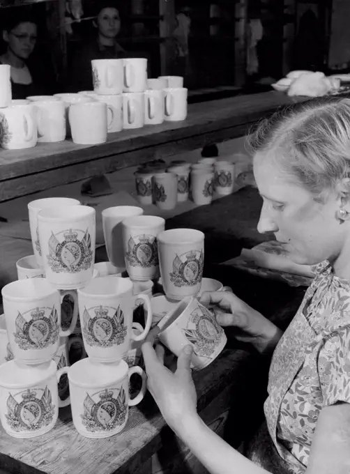 Coronation Mugs For The Overseas Market. Those Coronation mugs and beakers will soon be on their way overseas as samples from the Bristol pottery of Messrs. Pountney & Co. Ltd., who expect to start on a production figure of 40 dozens per week when orders are confirmed. Members of the staff are being specially trained to manufacture the Coronation ware, shapes, sizes and decoration which have been personally approved by the Queen. The mugs and beakers should be available to the public by next January. September 18, 1952. (Photo by Reuterphoto).
