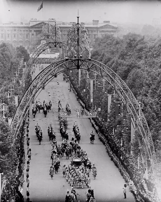 The Royal Progress Along The Mall Photographed from Admiralty Arch, the Royal Coach is seen coming along the Mall from Buckingham Palace, beneath the ornamental arches. June 2, 1953. (Photo by Fox).