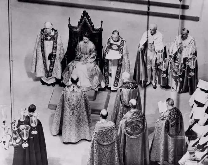 The Coronation Of Queen Elizabeth -- Queen Elizabeth II seated in King Edward's Chair during the Coronation ceremony in Westminster Abbey facing her is the Archbishop of Canterbury. Over her long robe the Queen wears a cloth of gold. June 2, 1953. (Photo by Planet News Ltd.).