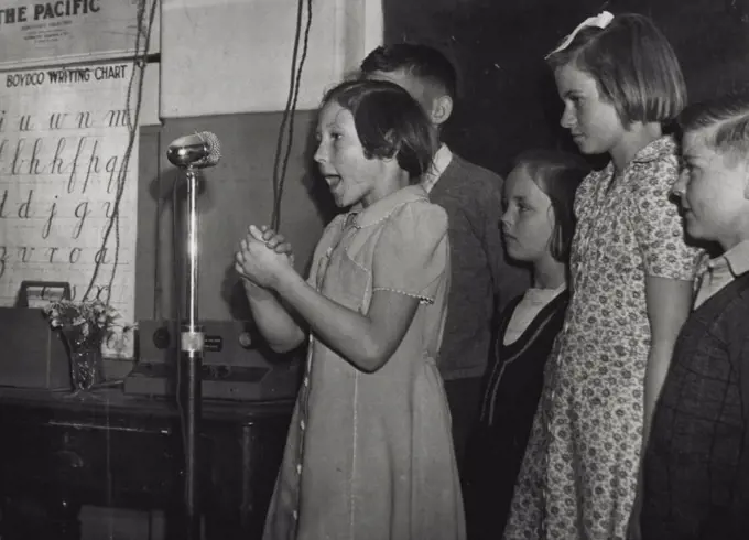 Girl reciting before an irritation microphone so as to overcome nervousness at a Mosman School. October 24, 1946.