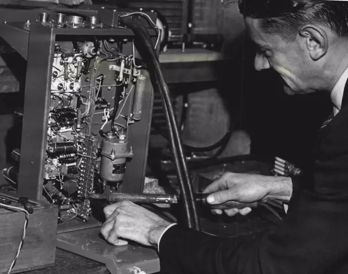 Mobile FM. transmitter has a wire soldered into place at AWA. research laboratories Ashfield, here experiments with frequency modulation communications have been carried out. June 28, 1946. 