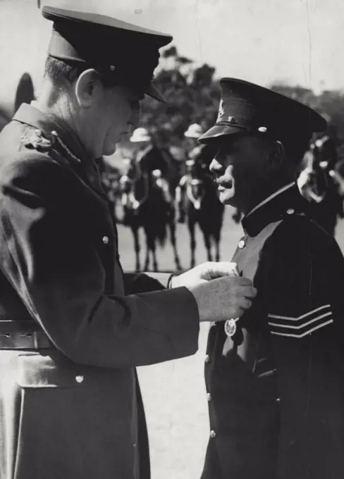 The governor lord Wakehard pinning king's police medal on breast of Sgt Tracker Alexander Relay. Sgt Reley is the first aboriginal police official to be so decorated. September 17, 1943. (Photo by Barry Newberry/Fairfax Media).