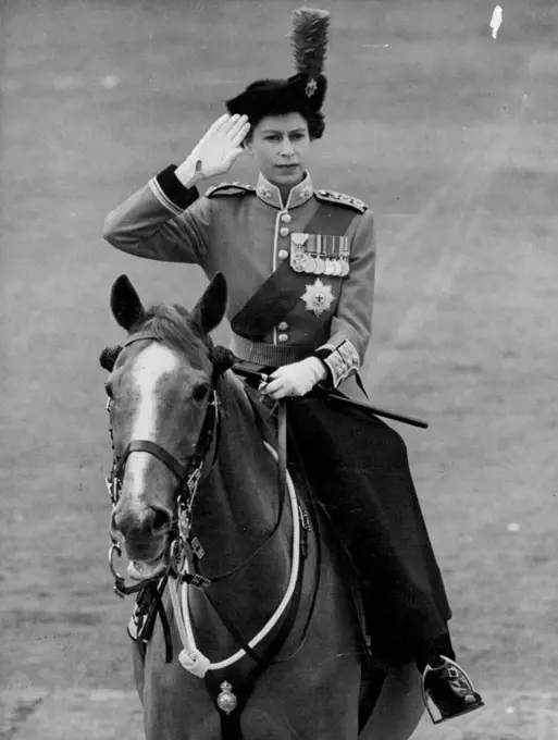 The Queen, mounted on the police horse, "Winston", takes the salute as the Guards march past the Palace to conclude the ceremony of Trooping the Colour. June 10, 1954.