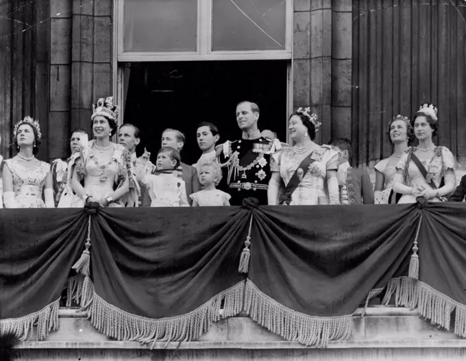 Queen Takes R.A.F. Salute - With a Pointer From Princes Charles -- Beside the smiling Queen wearing the Imperial State Crown Prince Charles points skyward from the balcony of Buckingham Palace 168 jet fighters fly over in the *****air force salute to her *****. January 01, 1953.