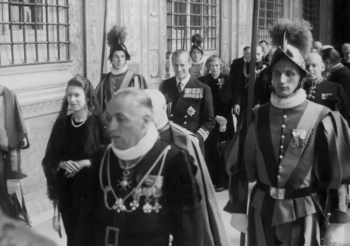 Princess leaves after Papal audience. - Princess Elizabeth is seen here passing through the Mantovani Loggia, Vatican City, followed by the Duke Edinburgh after their audience with Pope Pius X11, surrounded by Swiss Guards. and Vatican officials. Behind the Duke is Lady Palmer, Lady in waiting to the Princess. April 15, 1951. (Photo by Associated Press photo).