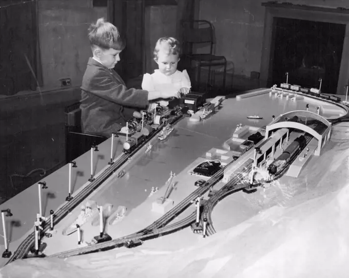 When Prince Charles arrives in Gibraltar he will be presented with this model of the Rock of Gibralter, complete with electric railway. It was made by boys of REME. Peter and Jacqueline Matthews are the lucky children sitting in the seats "reserved" for the Prince and Princess Anne. May 10, 1954. (Photo by Daily Mirror).