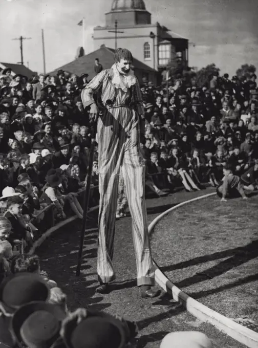 Clown on Stilts : Children were entertained at a circus party at Taronga Park Zoo yesterday. The clown on stilts, with his enormous walking stick, brought many a laugh. October 09, 1939.