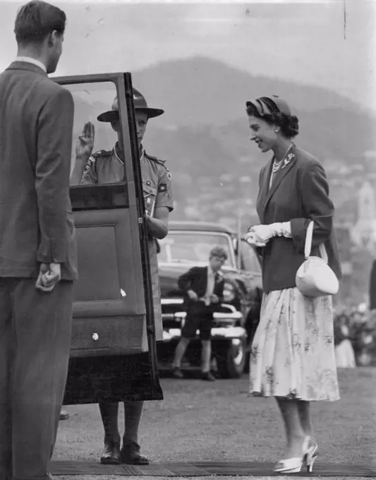 Salute. A boy Scout salutes the Queen as she enters her car in Hobart yesterday. The Queen had attended an ex-servicemn's rally. February 22, 1954.