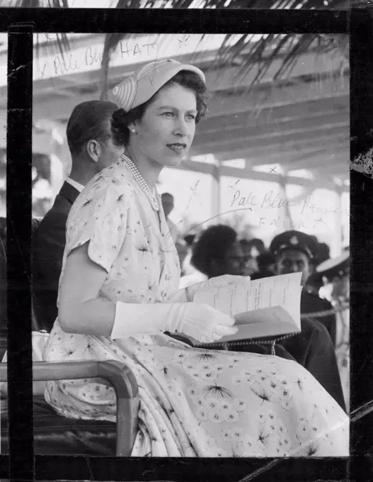 At Churchill Park, Lautoka, the Queen watches a sports meeting. Soon after, crowds mobbed her car. December 30, 1953.