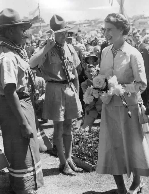 Queen Elizabeth greeting Samoan Scouts who were in the South Island for a jamboree. This picture was taken at Timaru, NZ.Colourful Dress - Scouts from Samoa, who were attending a jamboree near Timaru, will recall for many years the day they met the Queen. The scoutmaster salutes as Her Majesty talked to one of the scouts, whose colorful dress impresses the Queen. February 03, 1954.