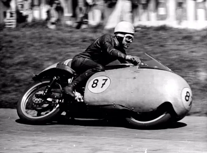 Duke Does It Again -- Australia's Ken Kavanagh at speed during the 350 CC Rave which he won on his Moto-Guzzi.Geoff Duke, Britains world 500 CC Motorcycle champion robe his 500 CC Gilera to Victory in the Rhine cup races at Hockenheim. Germany on Sunday.More than 120,000 fans saw him set up a lap record of 123.8. miles an hour, he covered the 20 laps in 47 minutes 12.5. seconds.Ken Kavanagh of Australia was second in this event and also won the 350 CC race on his Moto-Guzzi at 11.84 miles an Hour. May 10, 1955. (Photo by Paul Popper Photo, Paul Popper Ltd.).