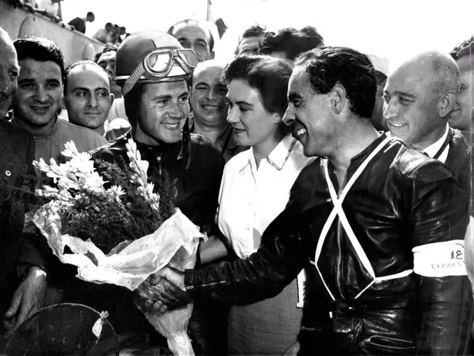 Duke Wins At Monza -- Ken Kavanagh (right) of Australia Congratulates Britain;s Geoffrey Duke, after the latter had won the 350 CC Motorcycle event of the grand Prix  Des Nations At Monza, Italy, September 9. Kavanagh was second, Both were riding Nortons.Britain's Geoffrey Duke, riding a Norton, won the 350 C.C. Motorcycle event in the grand Prix Des Nations At Monza, Italy, September 9. Second was Australian Ken Kavanagh, and Jack Brett, of Britain, was Third. Both the latter rode Norton. September 25, 1951. (Photo by Associated Press Photo).