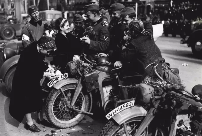 The Germans Enter Sudetenland.Girls decorating dispatch riders and their motor cycles with flowers when they arrived in Eger. October 27, 1938.