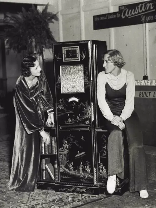 Radio Exhibition At The Olympia, London -- The new Austin "Grandfather Clock" radiogram Cabinet de Luxe with a Chinese Lacquer finish being shown at the Exhibition. September 24, 1934.