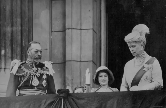 King And Queen On Buckingham Palace Balcony After Thanks Giving Service -The King and Queen on the balcony of Buckingham palace. With them Princess Elizabeth (waving to the crowd) and Princess Margaret Rose (head just appearing over balustrude), the daughters of the Duke and Duchess of York.After returning to Buckingham palace from the Jubilee thanks giving service in St. Paul cathedral, the King and Queen with other members of the royal family appeared on the cheers of the crowd. May 6, 1935. (Photo by Kosmos).