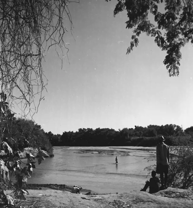Kruger Nat. Park - The most northerly boundary of the Game Preserve is formed by the Limpopo River. Picture shows junction of Limpopo and Pafuri Rivers. Native ranger in foreground. Far side of river is Mozambique.
November 25, 1948. (Photo by George Rodger, Magnum).