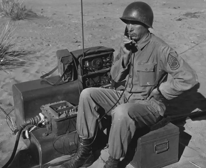 Look To The Skies -- Sfc. Millard Holman, Buford, Georgia, directs the firing of the sky sweeper from his position to the rear of the gun crew. Sfc. Holman is the section chief of the gun crew, battery a, 531st anti aircraft artillery battalion, Fort Bliss, Texas. December 02, 1954. (Photo by Official U.S. Army Photo).