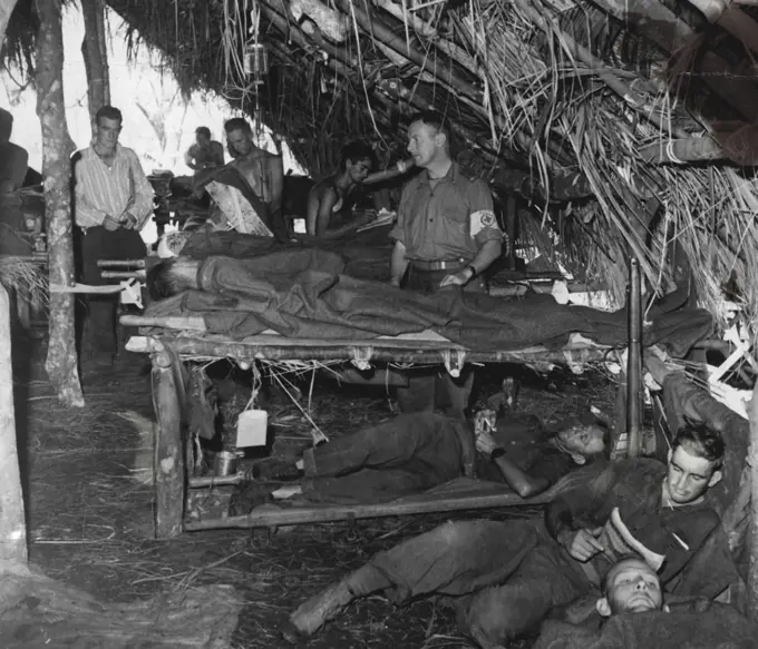 This is the most forward medical post in the battle area. At a mobile surgical team's headquarters wounded are shown on the floor and in beds. November 9, 1943.