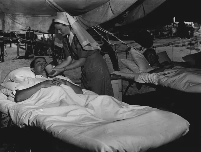 She served out meals and feeds the worst cases. Pillows are smoothed out and patients made comfortable. Tent sides are rolled up in the daytime to allow the sea breeze to cool off the wards. Temperature here in wet season has maximum average of 86.9 degrees; average minimum of 75.8 degrees. Average maximum temperature throughout year is 82.2; average minimum 68.5 degrees. Relative humidity average 73 percent in wet season. Yearly average is 68 percent. December 2, 1944.