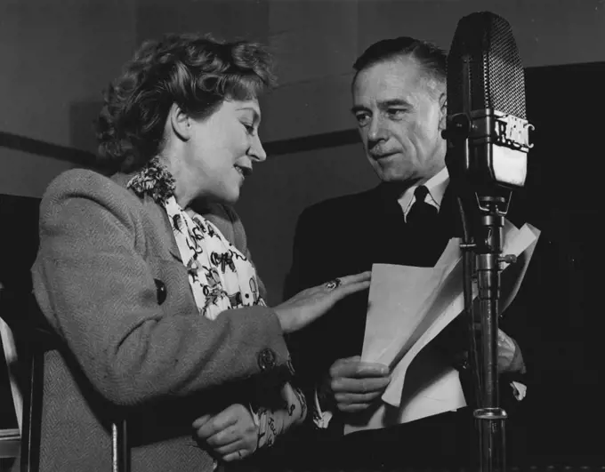Annette Mills returns to broadcast a programme of her own songs in the BBC Forces Programme, on November 3rd, 1943. C.F. Meehan, BBC Producer, welcomes her to the microphone. 
Annette Mills, the dancer who introduced the Charleston to Great Britain, and the composer of 'Boomps-a-daisy', has been in hospital for a year following a serious motor accident which occurred while she was driving between two R.A.F. stations to entertain the airmen. She suffered eight fractures, and is still dependent upon crutches and a sling. On November 4th, the day after this broadcast, she returns to hospital for what she hopes will be her final operation. November 03, 1943. (Photo by BBC).
