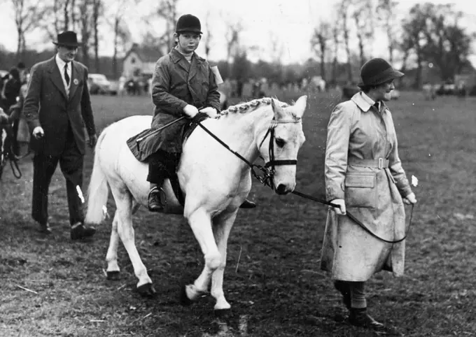 Royal Jumper At Iver Village Horseshow -- Prince Michael of Kent on his white pony "Pearl", pictured as he is led up to the start of the Class II event at Iver Village Children's Horseshow and Gymkhana (Huntsmoor Park, Monday).He won a second prize. April 11, 1950. (Photo by Fox Photos).
