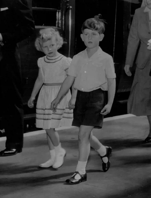 Just To Children Going On Holiday -- In simple holiday dress, Prince Charles and his sister, Princess Anne, walk ***** the train on arrival at Portsmouth to-day (Friday) from London to ***** Royal yacht Britannia.
They will join their parents, the Queen and the Duke of Edinburgh, on an eight-day cruise.
During this, the Royal couple will be fulfilling engagements in Wales, the Isle of Man, and Scotland. August 05, 1955. (Photo by Reuterphoto).