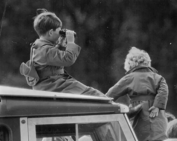 A Royal View -- Princess Anne, and her brother, The Duke of Cornwall use binoculars to watch the jumping in today's (Friday's) European Horse Trails at Windsor Great Park.In the Royal Party watching today's event were The Queen, the Duke of Edinburgh, Princess Margaret and the Princess Royal. May 20, 1955.