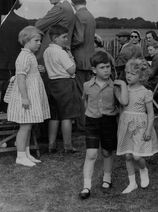 "Don't look now but there's somebody watching us."
Princess Anne and Prince Charles chatter thoughtfully in a quiet moment at the Household Cavalry polo tournament last week at Windsor Great park.
Girl on left seems to be comparing dresses. June 23, 1955.