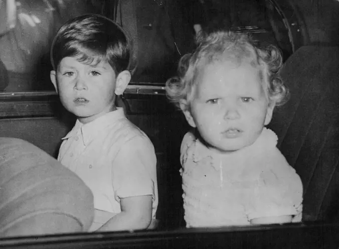 Prince Charles And His Sister After Birthday To Queen Mary -- Prince Charles (left) gazes calmly and Princess Anne with intense curiosity at the Crowes gathered outside Marlborough House, London, to-day (Monday) as the Royal children drive away after calling on their great-grandmother Queen Mary, to with her many happy returns on her 86th birthday. May 26, 1952. (Photo by Reuterphoto).