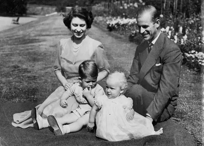 A Young Royal Family At Home -- This group, by our Cameraman Stanley Devon, was taken on the lawn in the gardens of Clarence House, the Royal Couple's London Residence.
One of the busiest and hardest-working young couple in the World are Princess Elizabeth and the Duke of Edinburgh.
After his return on July 21st from naval duties in the Mediterranean, the duke was immediately plunged into a round of official functions in Britain. Then on September 25 the Royal Couple will leave on a visit to Canada where they will spend several weeks as guest of the governor-general, viscount Alexander. As a conclusion to their travels on the American continent, they are to spend October 24th and 25th at the white house as guests of President Truman. August 09, 1951. (Photo by Paul Popper).
