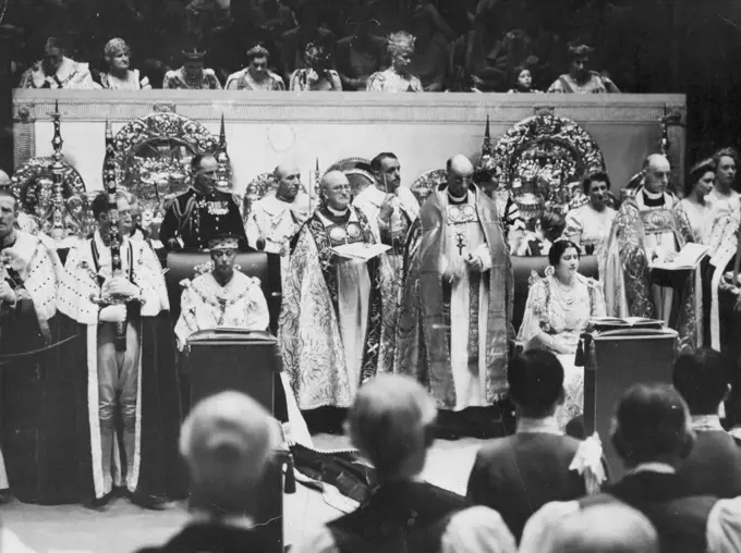 The King And Queen During The Coronation Service -- King George (sitting, on left) and Queen Elizabeth (sitting of right) during the coronation service in Westminster Abbey. The Royal Ladies in the Royal Box above are (left to right, star ONG second from left) Duchess of Kent, Duchess of Gloucester, Queen Maude of Norway, Queen Mary, Princess Elizabeth, Princess Margaret Rose.Amid Glittering Scenes of Traditional splendour the king and Queen rode to Westminster Abbey from Buckingham palace to be crowned. A Buge, colourful Procession accompanied the State coach. February 9, 1952. (Photo by Associated Press Photo).