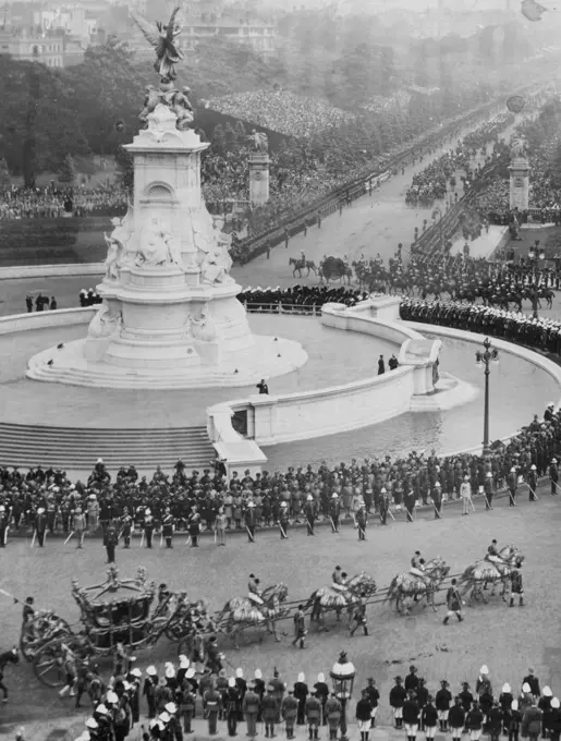 The Coronation - 1911 -- The approaching Coronation of King George VI  at Westminster on May 12th, brings back memories of the last Coronation - that of his father King George V.
This interesting picture, taken from one of the windows of Buckingham Palace, shows: The Royal Coach Departing On Its Way To The Ceremony for the Coronation of King George V in 1911.
The Victoria Memorial can be seen very prominently in this picture. April 26, 1937.