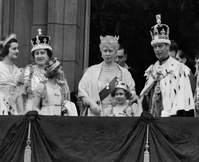 King George VI, wearing the Imperial State Crown, on the balcony of Buckingham Palace after the Coronation where he acknowledged the cheers from the vast crowds that had gathered to acclaim the newly-crowned Sovereign. With him are Queen Elizabeth, Queen Mary, Princess Elizabeth and Princess Margaret. The Princesses are wearing their coronets which they put on with the Peeresses, after the crowning of the Queen. June 3, 1953.