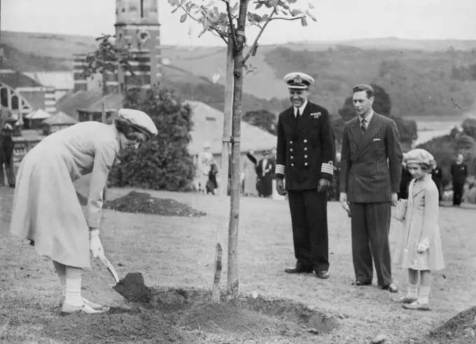 Royal Visit To Dartmouth -- Princess Elizabeth planting her tree in the College grounds, watched by the King and Princess Margaret Rose, at Dartmouth yesterday.The King and Queen and the Princess each planted a tree in the college grounds, during their visit to the Royal Naval College at Dartmouth yesterday. July 23, 1939. (Photo by Keystone).