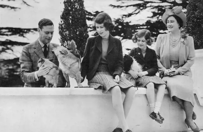 Their Majesties With The Princess -- A Charming picture of their Majesties the King and Queen with the Princess Elizabeth and Margaret and their pet dogs.  August 04, 1940. (Photo by London News Agency Ltd.)