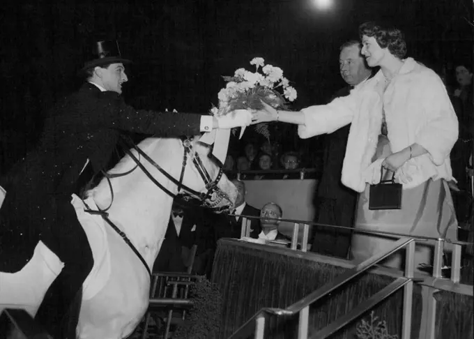 Cavalier's Bouquet - With courtly gesture, noted horseman Albert Schumann leans from his saddle to present a bouquet to Princess Alexandra of Kent at the Tom Arnold Christmas Circus at Harringay Arena, North London, this evening (Wednesday). Albert Schumann, a star of the show, from Copenhagen, is a member of a noted Danish circus family. December 22, 1954. (Photo by Reuterphoto).