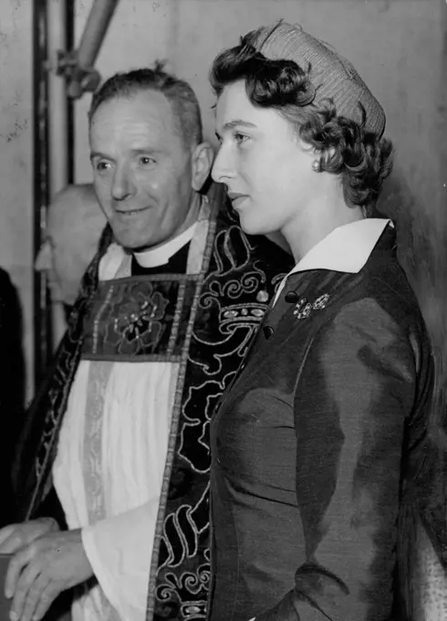 Her First Foundation Stone - Princess Alexandra, wearing two diamond horse-shoes on her grey dress, with the Rev. R. McIntyre. Princess Alexandra of Kent, 17-year-old cousin of Queen Elizabeth, Laid her first foundation stone yesterday, at the new. St. Paul's Church of England school, Walworth, London. The new $70,000 school will house 450 students, compared with 300 at the present school. May 07, 1955. (Photo by Paul Popper, Paul Popper Ltd.).
