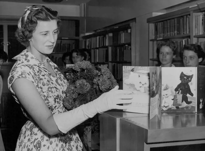 Royal Visitor - Princess Alexandra, daughter of the Duchess of Kent, seen looking at some French "Fairy Tale Books" in the Library of the new wing of the Royal foundation of Greycoat hospital, Westminister, today which the Princess opened. The hospital is now used as a girls school. July 18, 1955. (Photo by Paul Popper, Paul Popper Ltd.).