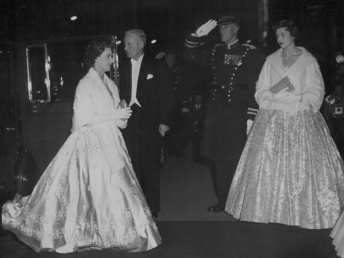 Royal Variety Show Smash Hit - As a Commissionaire salutes, Princess Margaret and Princess Alexandra arrive for the Royal show. July 11, 1955.
