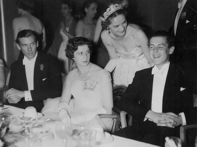 Lively Party - Sharing a joke at the Rose Ball at the Grosvenor House, London, last night are Mr. James Ogilvy and Lady Howard de Waldon. (Standing) Princess Alexandra in a ***** dress of white tulle is seated at left. May 5, 1955. (Photo by Evening Standard Picture).