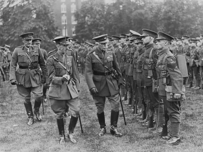 Duke Of Connaught Inspects London Irish Rifles Today -- Photo taken today Sunday, at the Duke of York's Head-quarters shows. The Duke of Connaught inspecting member of the London Irish Hifles. The Regt. leaves today for Ireland to enjoy their annul training. This is the first time a Territorial unit has left England for their annual training. July 19, 1931. (Photo by Photopress).