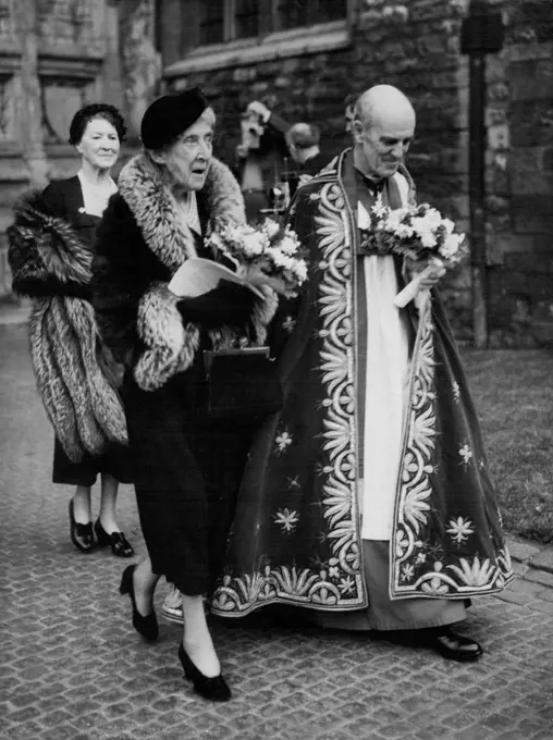 Princess Marie Louise At Maundy Money Service -- Princess Marie Louise, deputising for the Queen mother, accompanied by the Dean of Westminster, Dr. Alan C. Don, at the Royal Maundy service at Westminster Abbey, London, to-day (Maundy Thursday). The Princess distributed the Maundy coins - to every recipient a penny for each year of the Queen's life. The ceremony dates back to the days when the monarch washed the feet of the poor, symbolising Christ's laving of the Apostles' feet. April 15, 1954. (Photo by Reuterphoto).