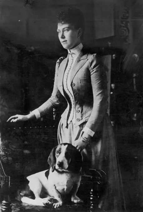 Princess May and her dog. This attractive portrait of Queen Mary in a beautifully cut tailor made of the period was taken just before her marriage in 1893. February 11, 1935. (Photo by Empire Press).